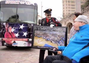 Auston O'Neill, left, of Bugles Across America, speaks with army veteran Daniel Castillo, right, and Castillo's caregiver, Marcela Rivas Ortega 