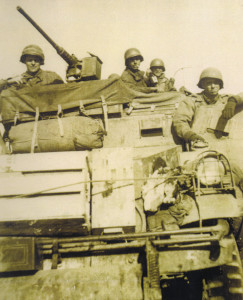 From left to right: S/Sgt John Fague, PFC Donald E. White, PFC Dock E. Deakle, and driver of the “BAT,” T/5 Orvin P. Rasnic